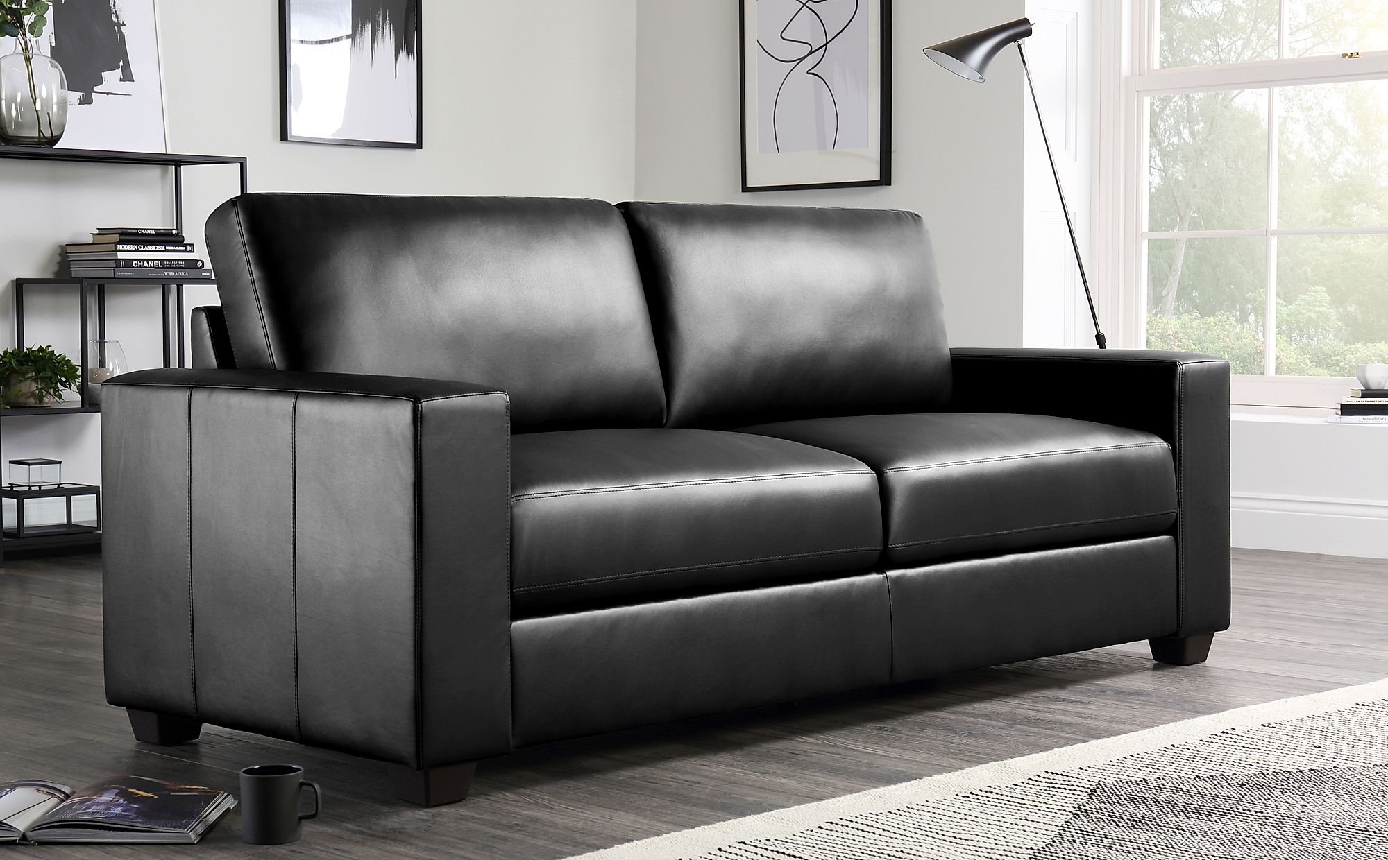 black leather three seater sofa
