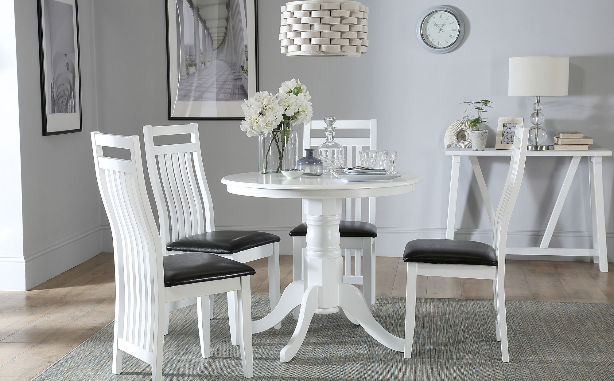 white kitchen set with round table and padded chair cushions