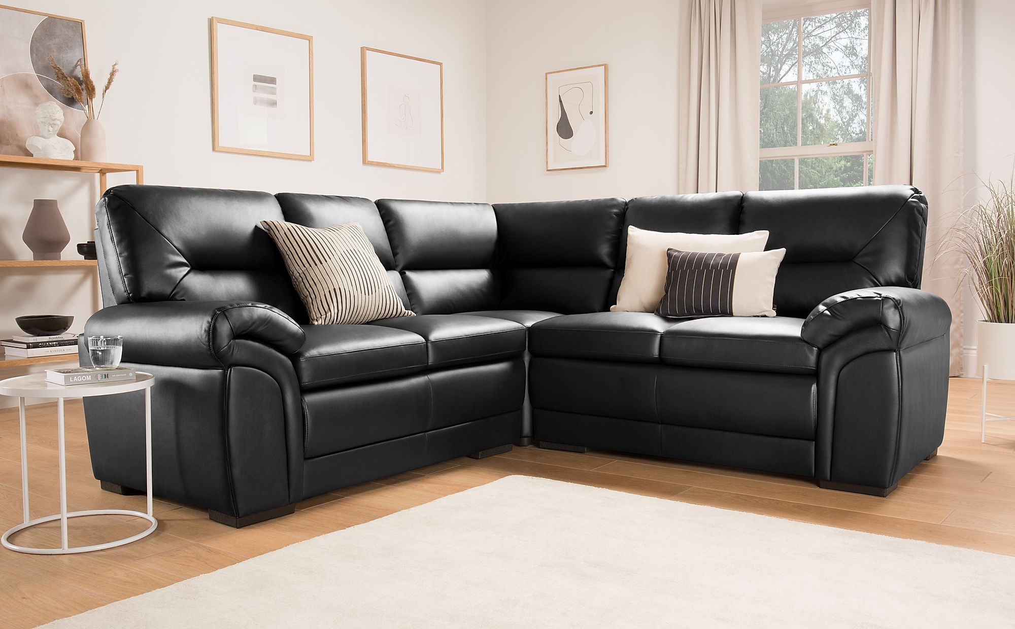 black leather corner sofa with matching rugs
