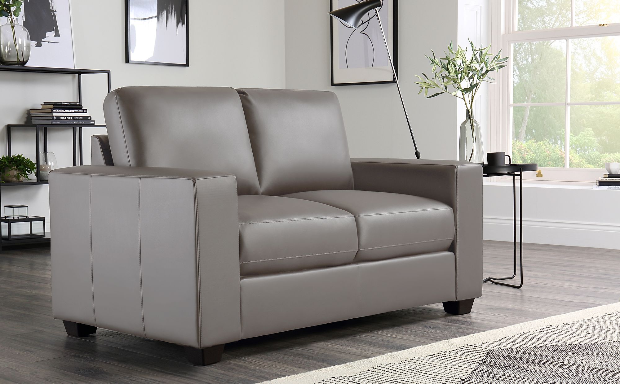 taupe chair with black leather sofa