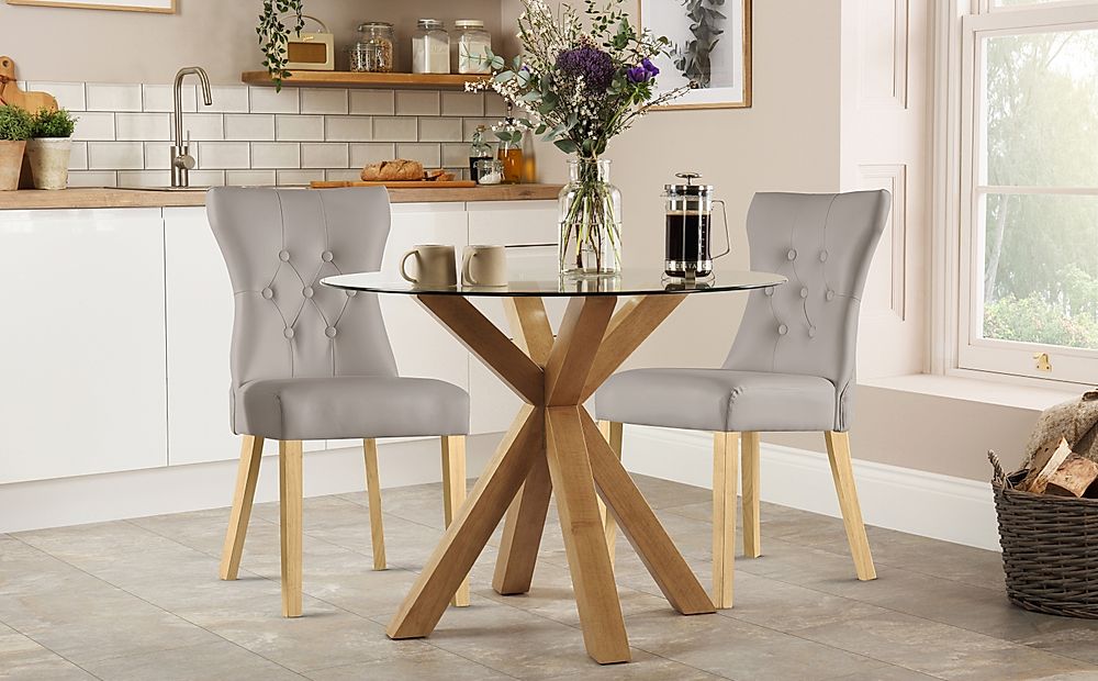 Hatton Round Dining Table & 2 Bewley Chairs, Glass & Natural Oak Finished Solid Hardwood, Stone Grey Classic Faux Leather, 100cm