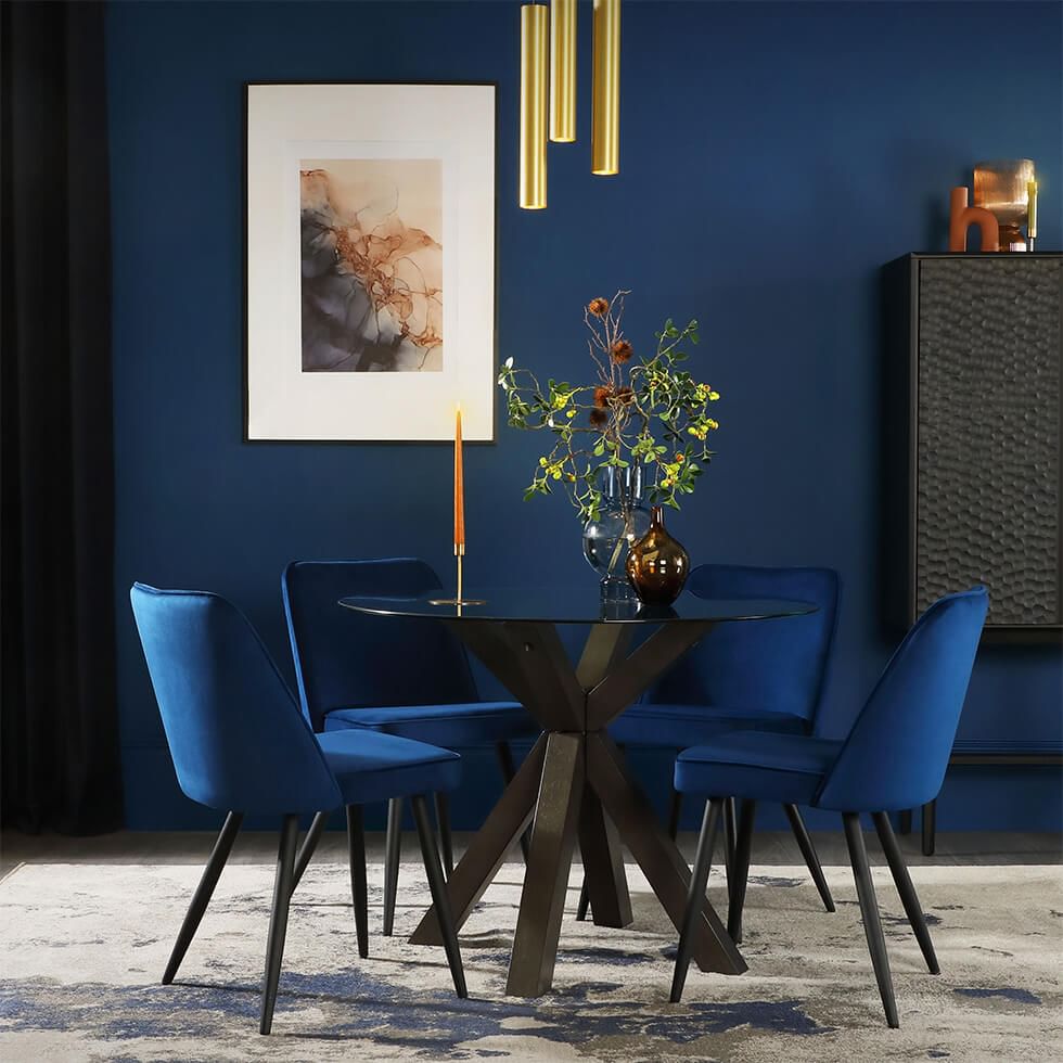Classic blue dining room with glass dining table and blue velvet dining chairs