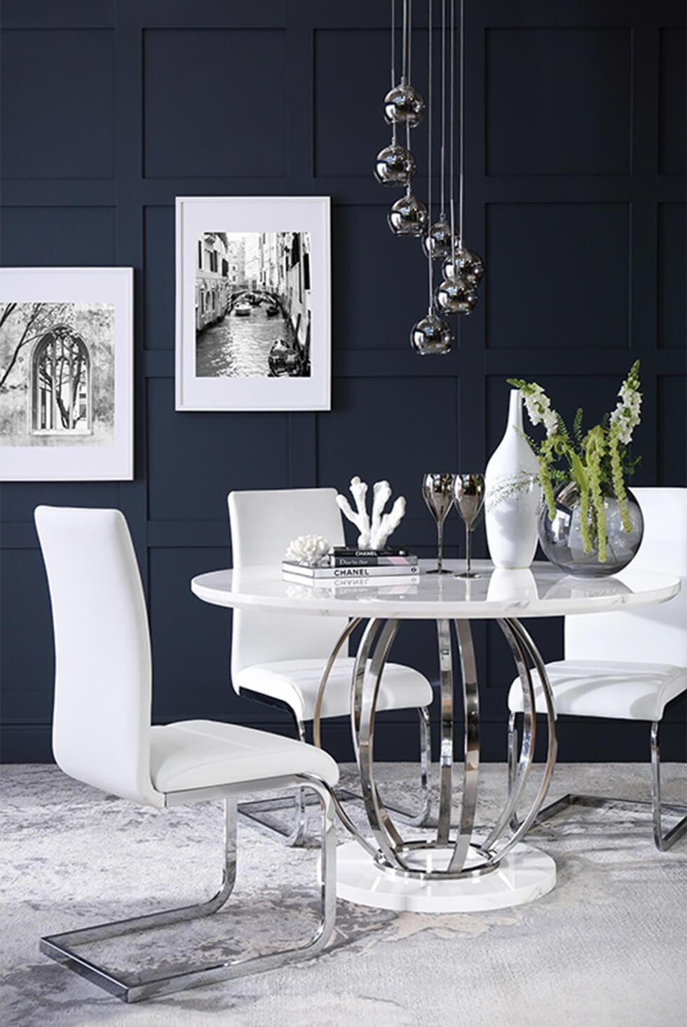 white marble and chrome table in a modern navy dining room