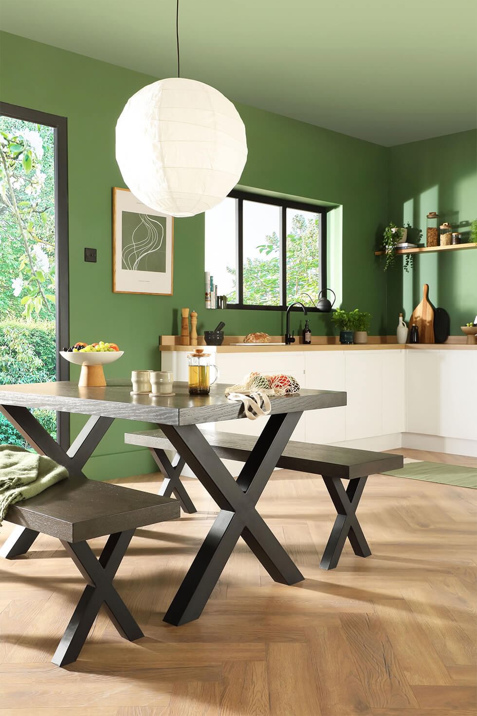 Forest green walls and grey dining set in kitchen-diner