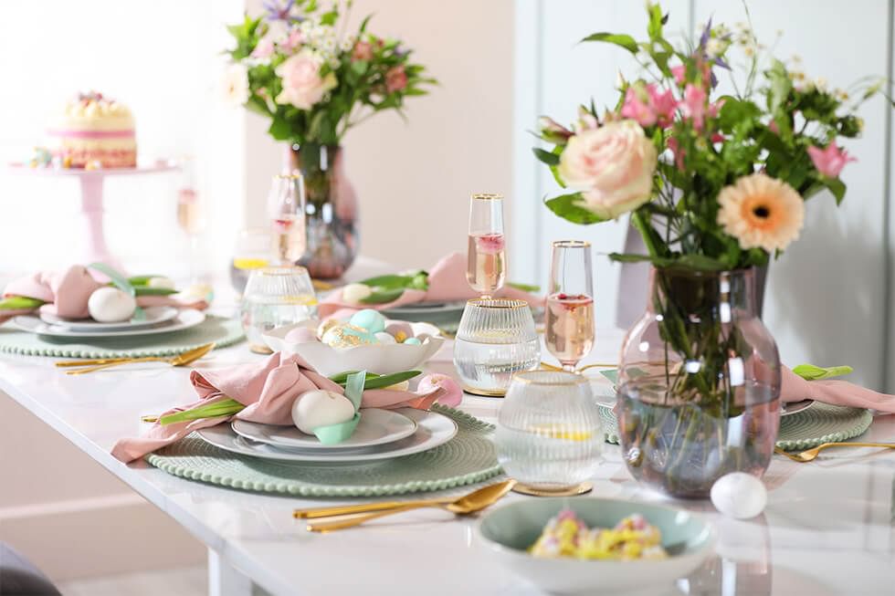 Blush pink dining room with marble dining table and colourful florals