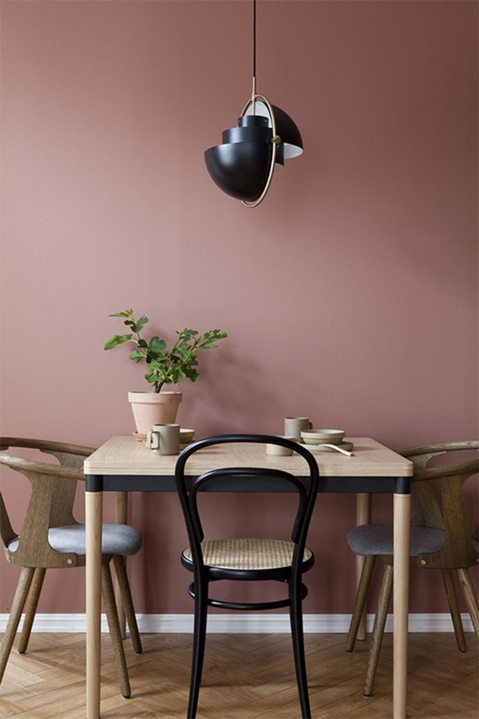 two tone light wood and black dining set in a mauve nordic dining room