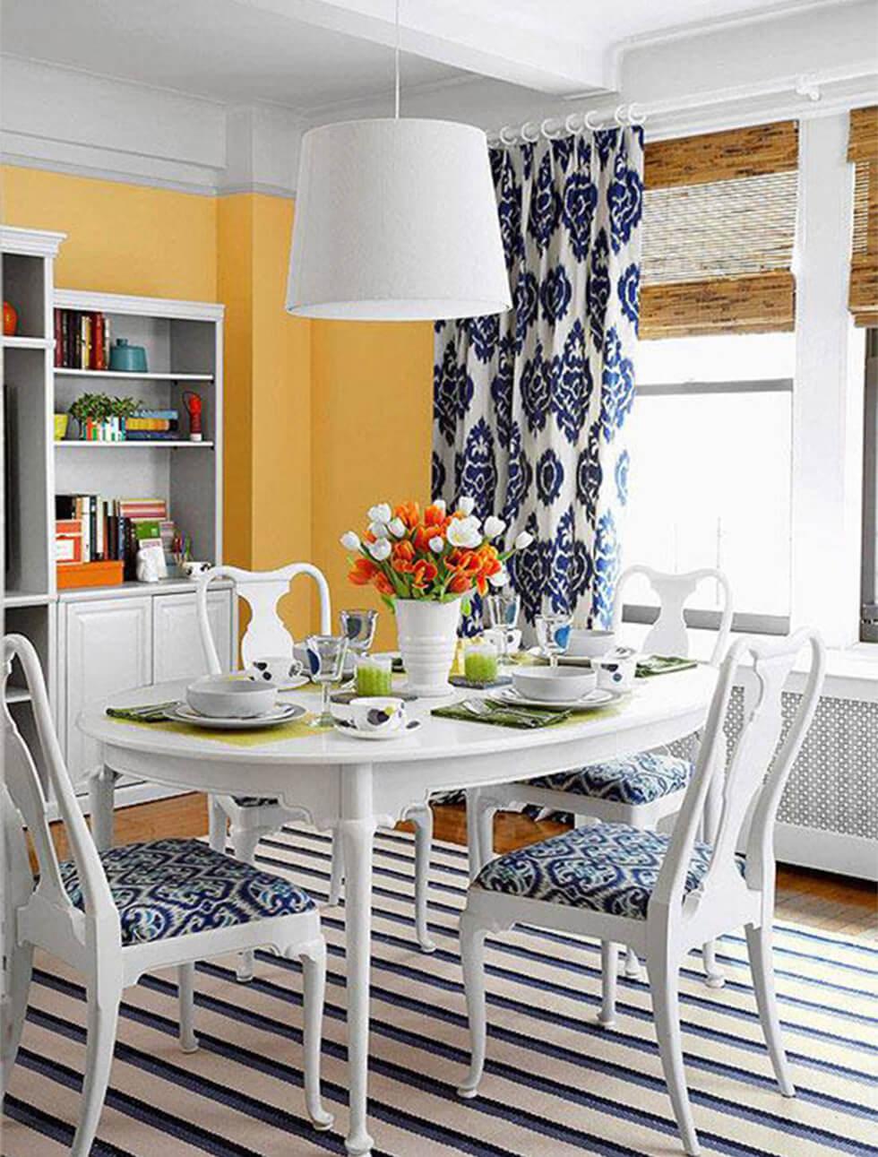 marigold orange walls in a French farmhouse dining room