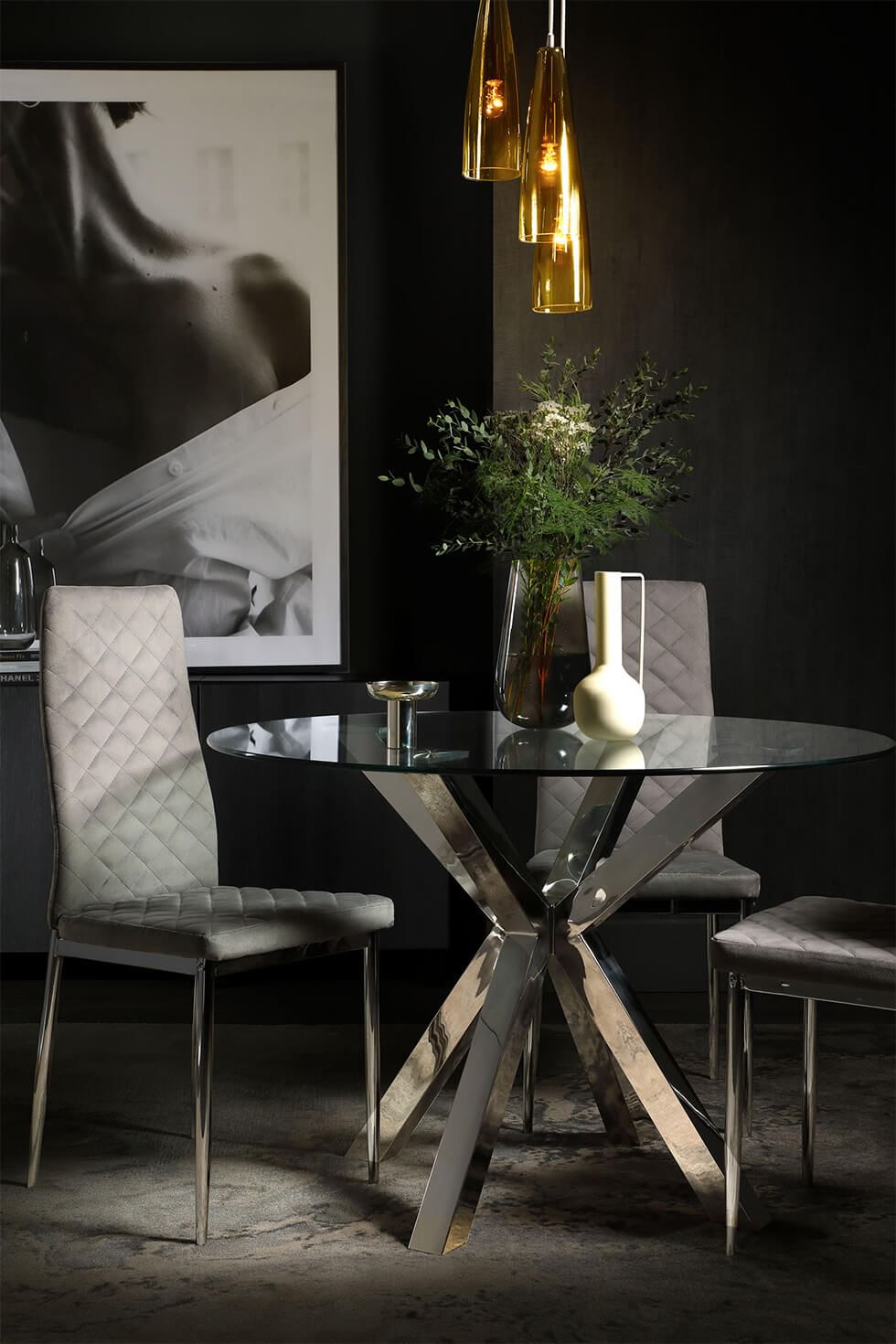 Black dining room with sleek glass and metallic dining set