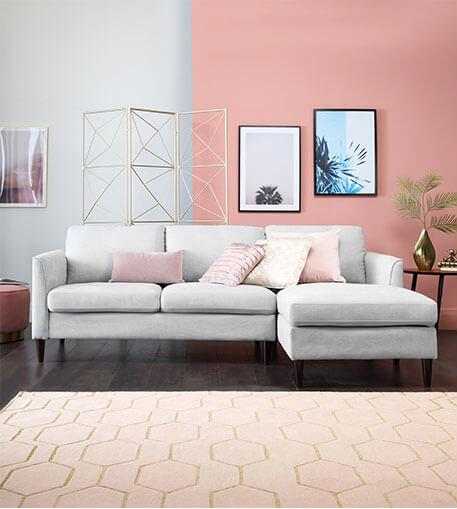 Light grey sofa in a light pink room.
