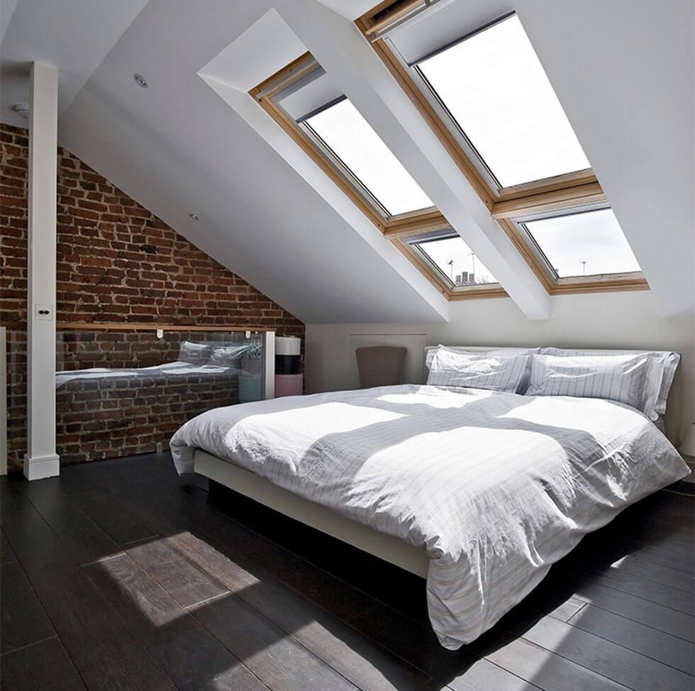 Light and airy loft bedroom with large windows