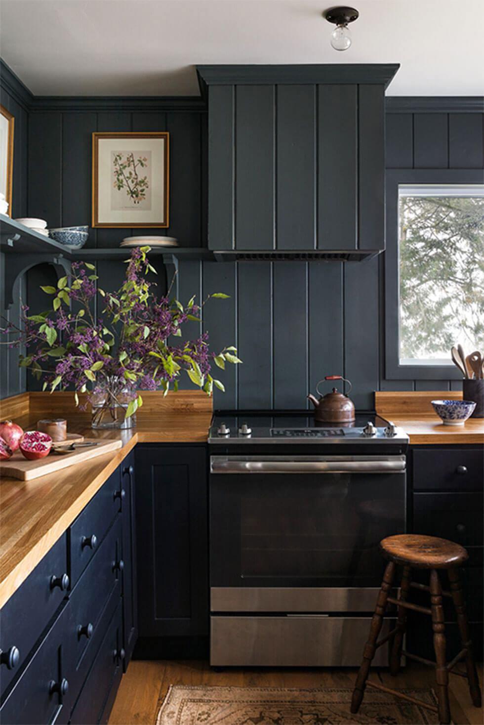 Dark grey small kitchen with a white ceiling and wooden counter tops