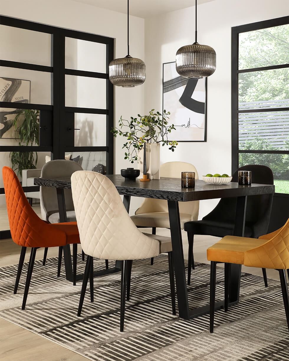 Dining room with a stylish dining table and dining chairs in different colours