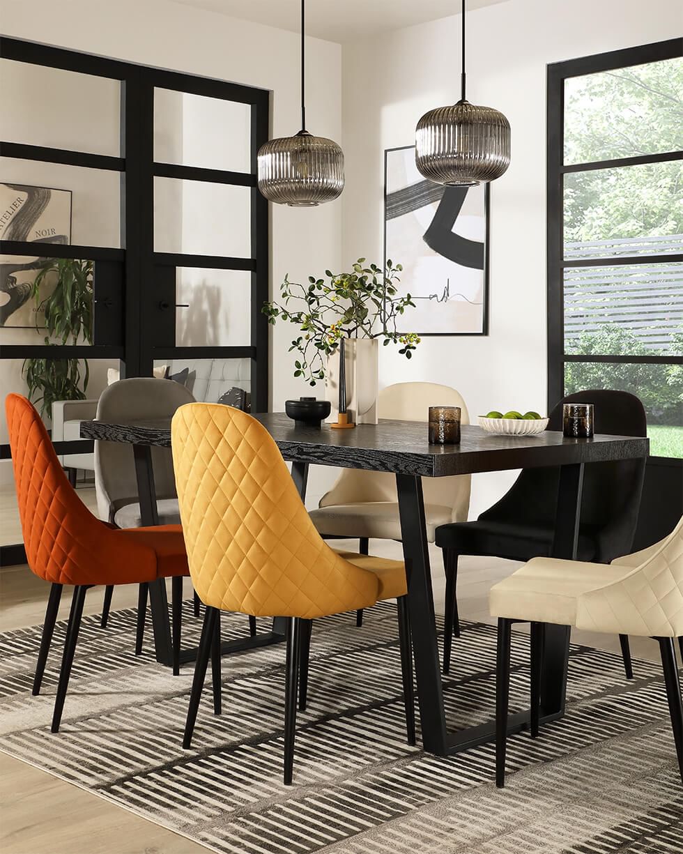 Sleek dining table with mismatched dining chairs in different colours