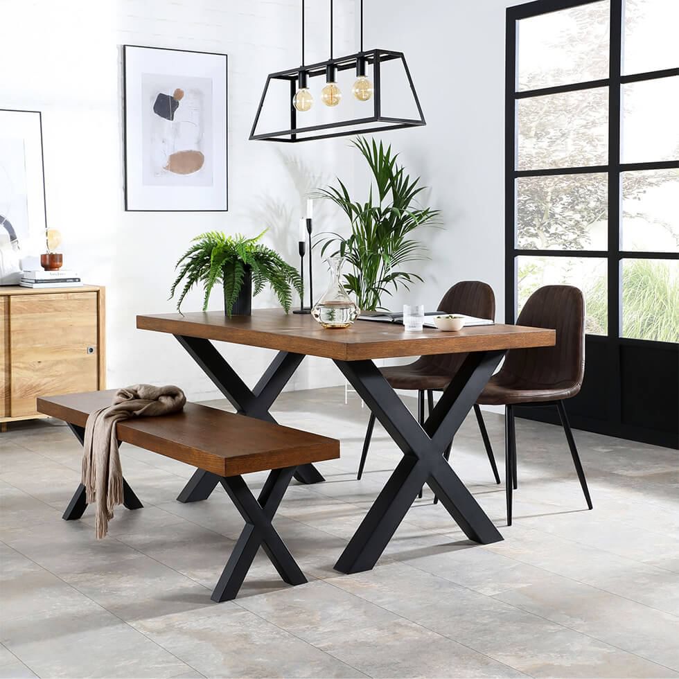 Dining room with brown chairs, a wood and steel table, and a matching bench