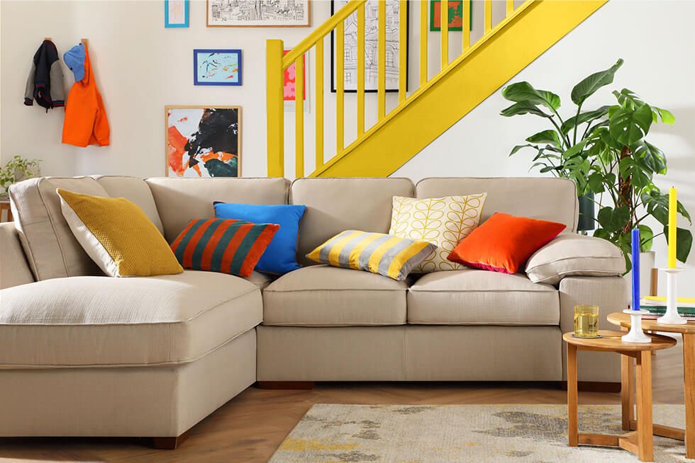 Fabric sofa in a neutral living room with small pops of yellow