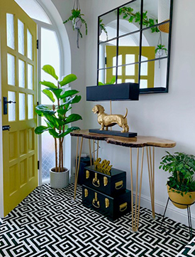 Yellow door and metallic light in a neutral tone entryway