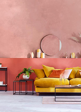 Jewel tone pink walls with a yellow sofa in a contemporary living space
