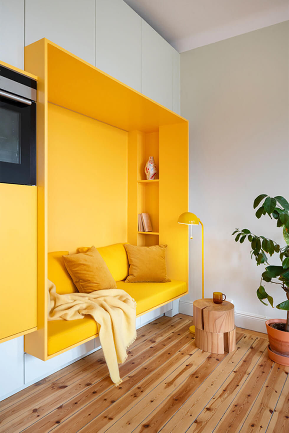 right yellow reading nook with warm oak floorboards