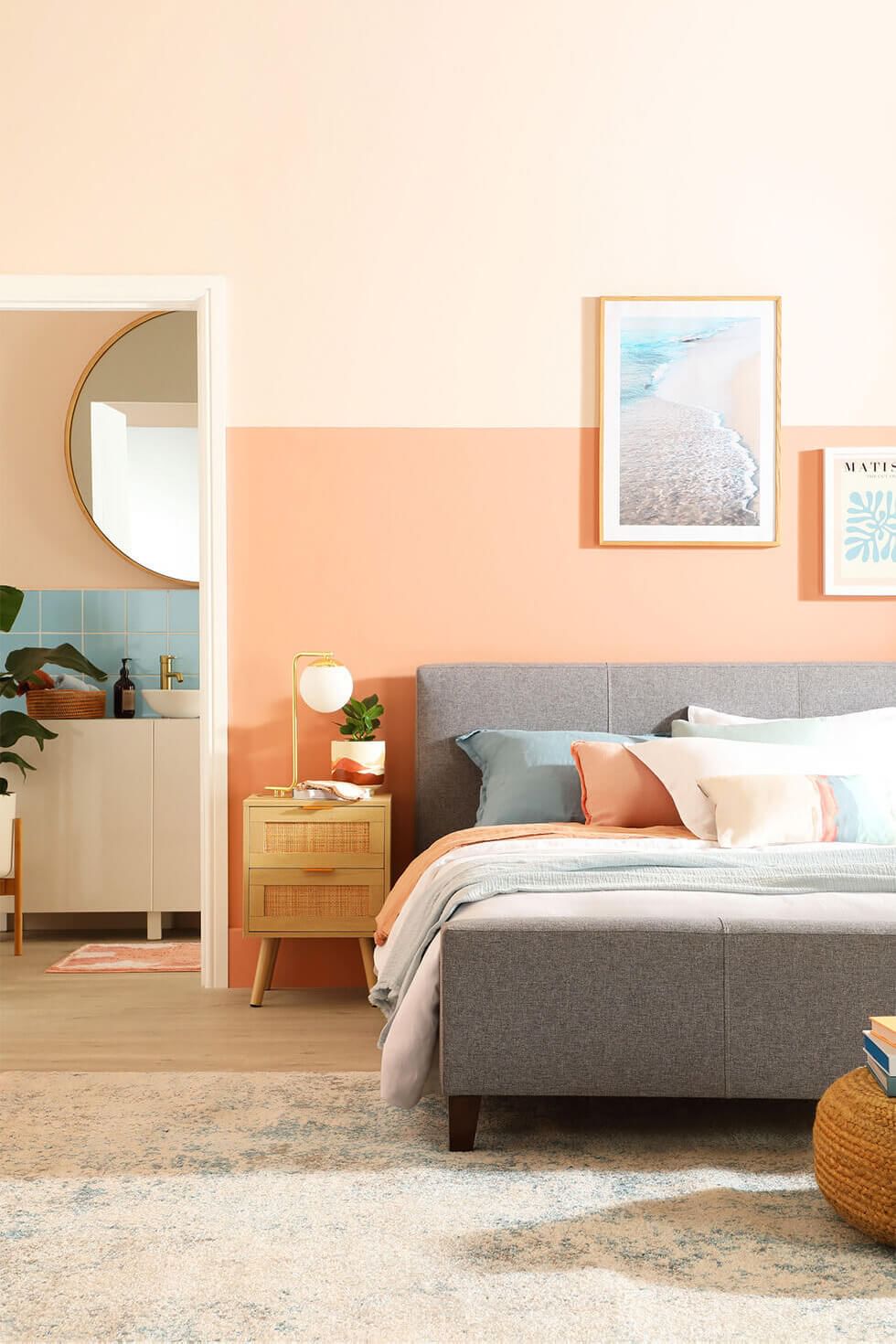 Bedroom wall painted in pantone colour of the year, peach fuzz
