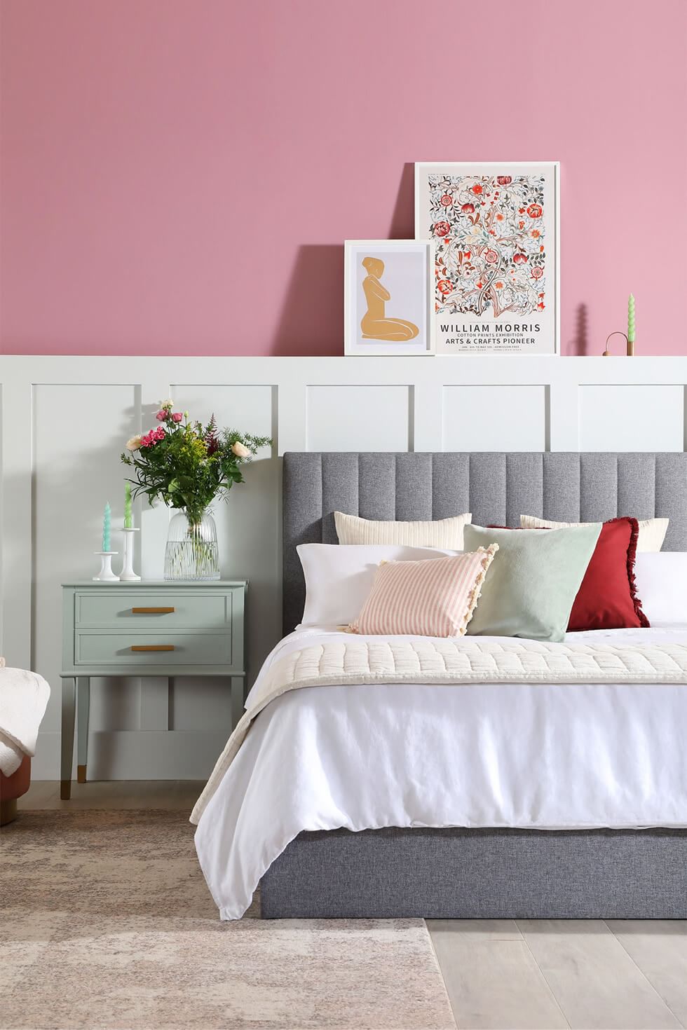 Stylish bedroom with a soft pink wall and cosy bed
