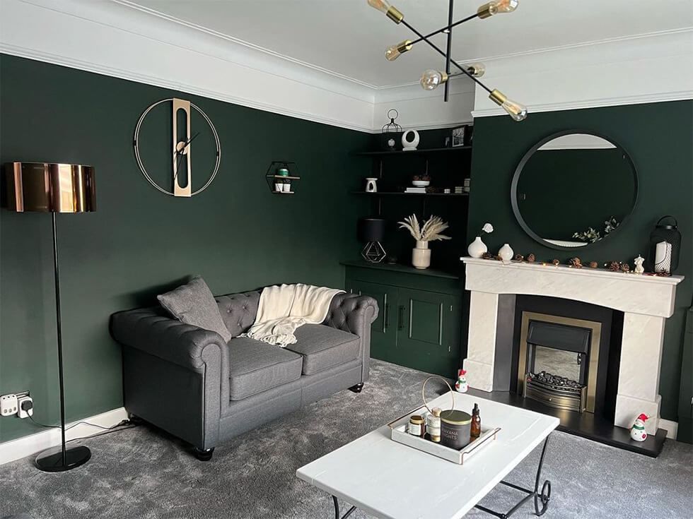 Classic living room with dark green walls and luxe decor