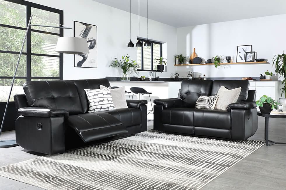 Black recliner sofa in a neutral living room