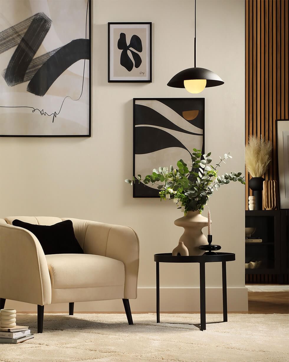 Neutral coloured living room with minimalist art and an accent chair