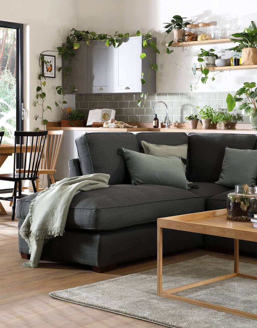 Scandi living room with lots of plants and cosy sofa