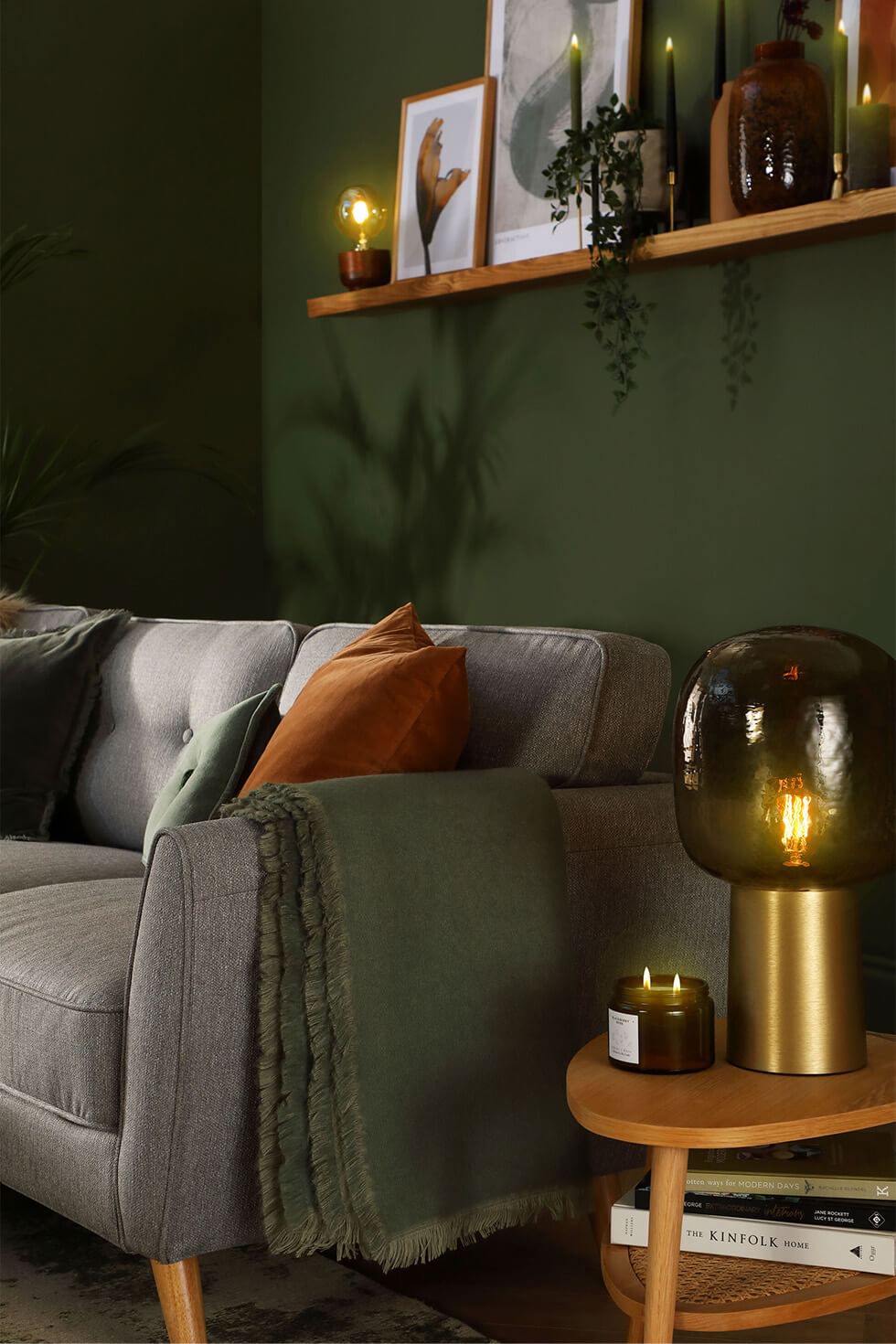 Cosy living room with glowing candles and a grey fabric sofa