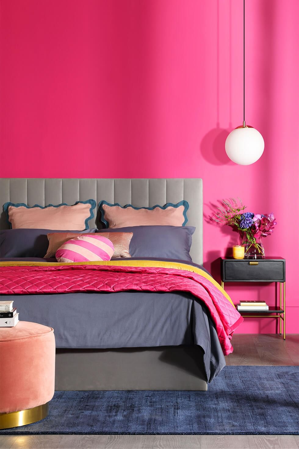 Comfy velvet bed in a hot pink coloured maximalist bedroom