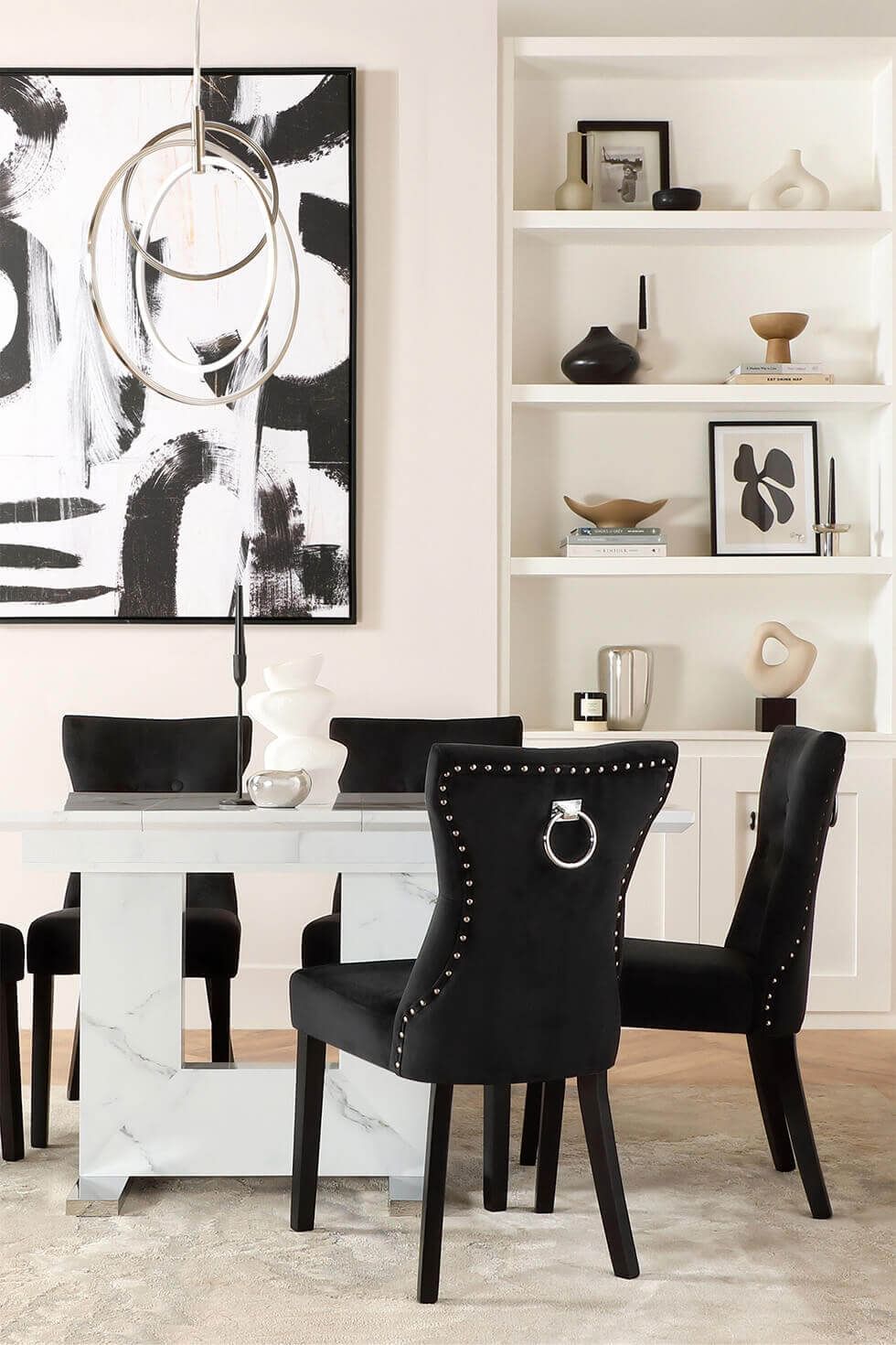 White marble effect dining table and velvet dining chairs in a maximalist room