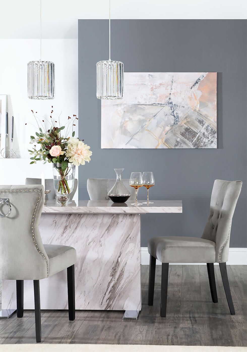 Grey dining room with grey dining chairs and a marble effect dining table