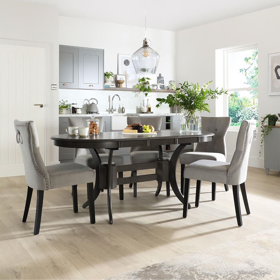 Open plan kitchen diner with grey kitchen cabinets and grey dining set