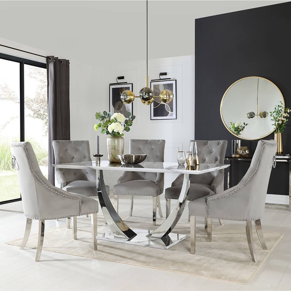 Chrome dining table paired with grey dining chairs upholstered in luxe velvet