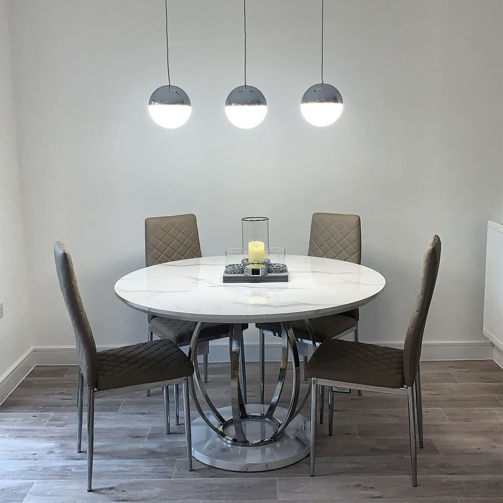 Grey dining room with warm lighting and a stylish dining set