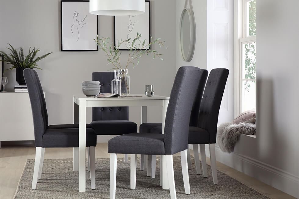 Grey monochrome dining room with dark grey dining chairs and a white dining table