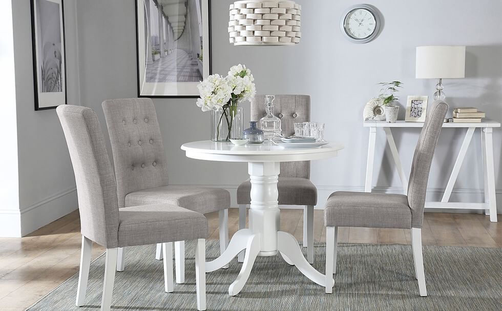 Scandinavian grey dining room with grey fabric dining chairs and a white dining table