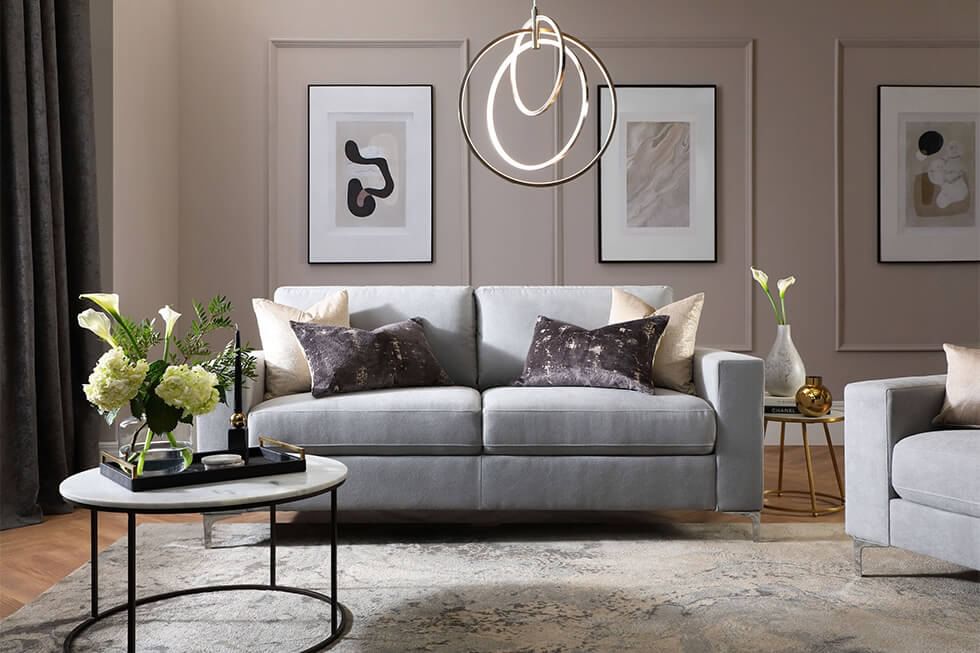 Elegant grey living room with a grey sofa and feature wall