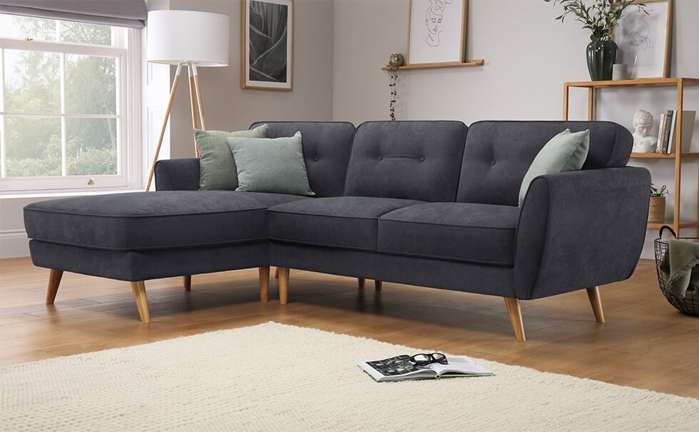 Grey sofa with wooden legs in a Scandinavian style grey living room