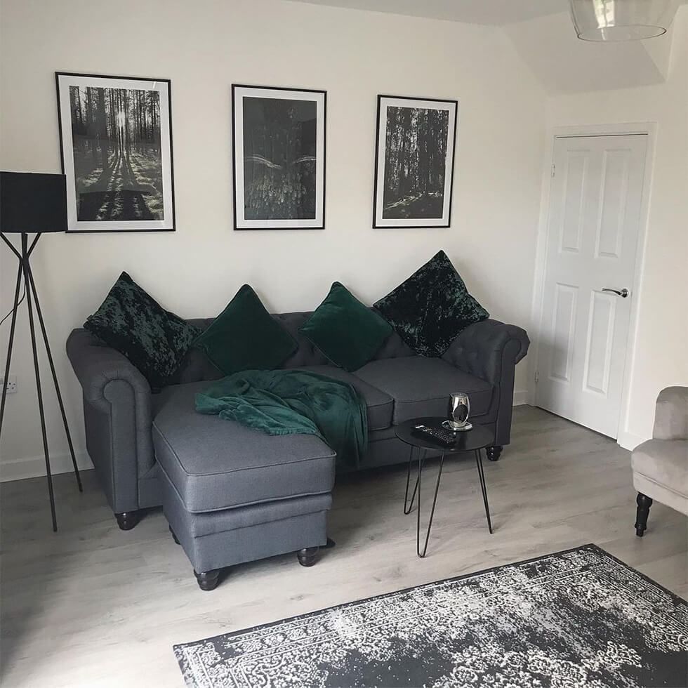 Grey living room with a grey sofa and grey gallery wall