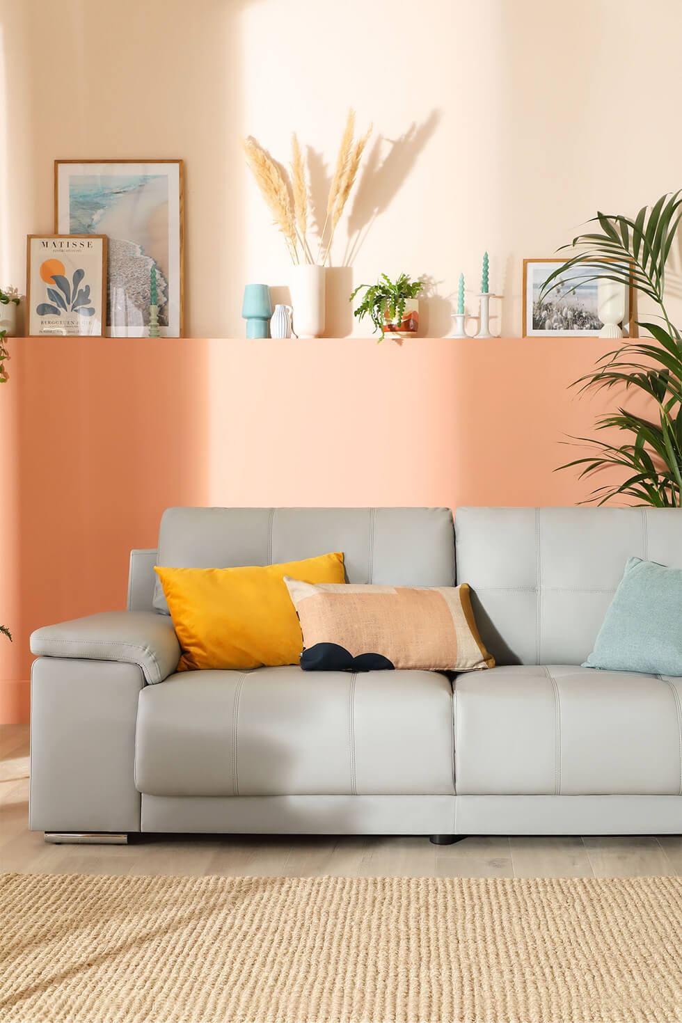 Stylish living room featuring a grey sofa and peach wall