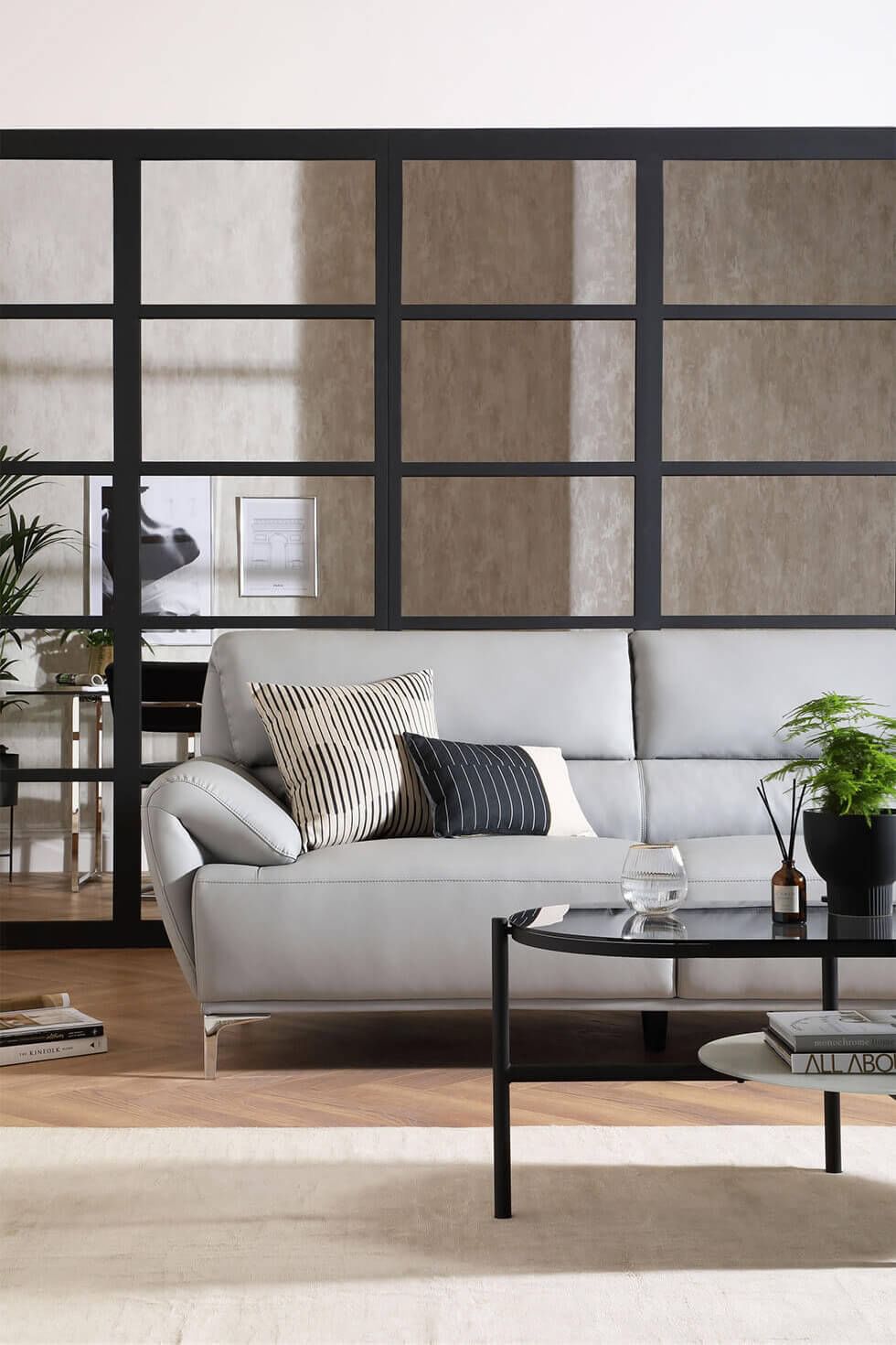 Modern grey living room with leather sofa and Crittall doors