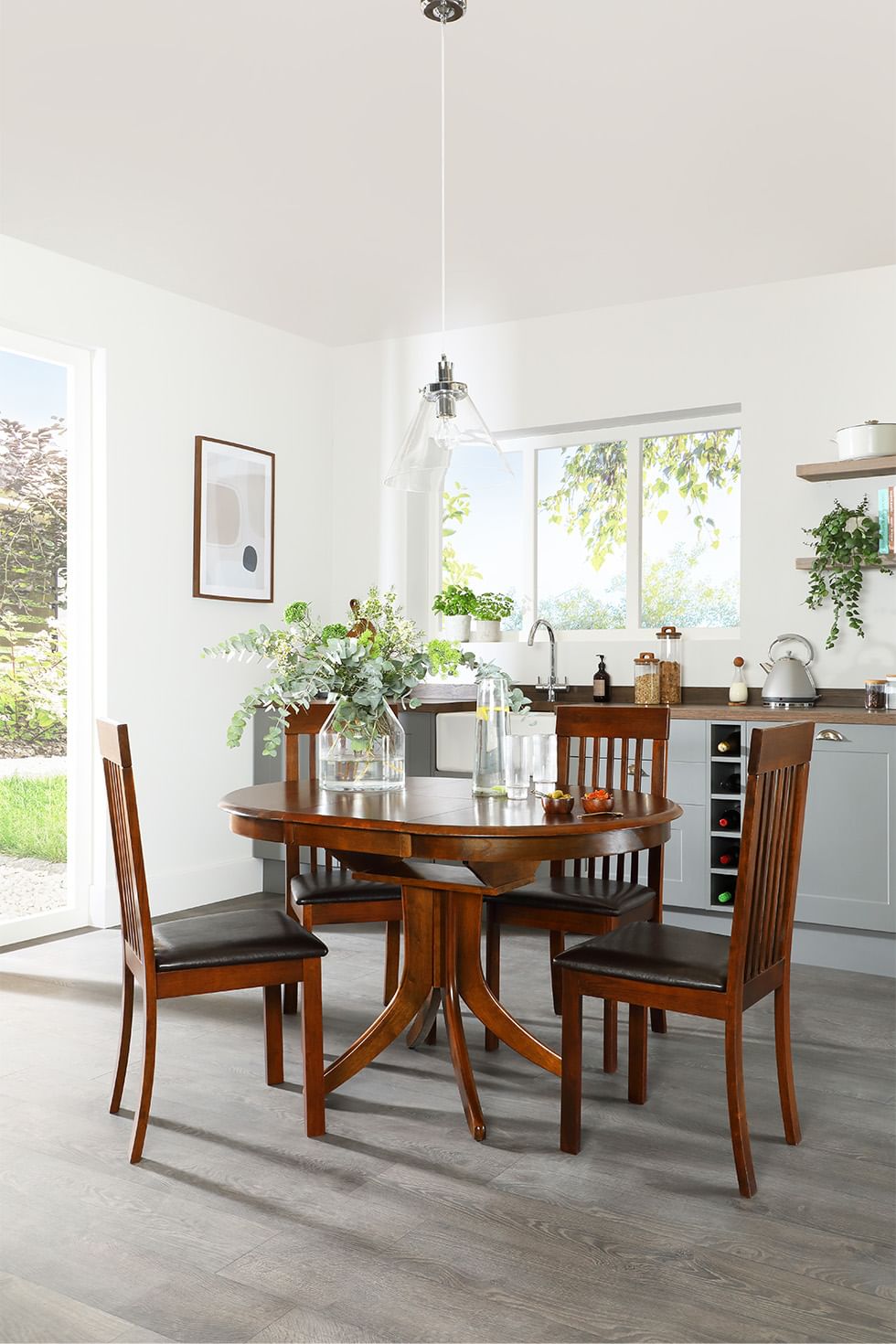 Dark wood oval-shaped dining table in a small dining room