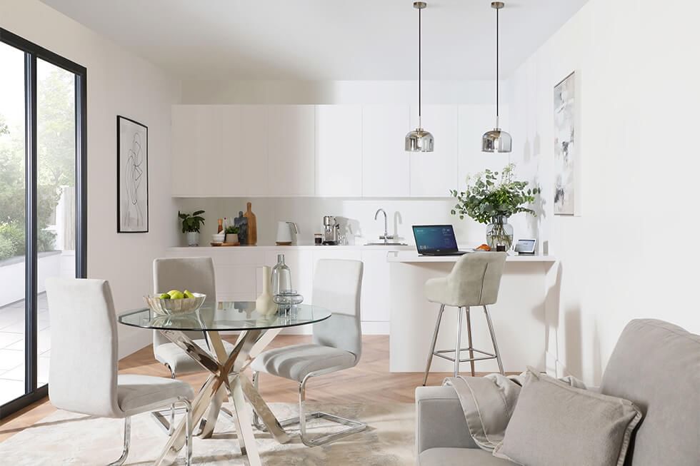 Small round dining table in an open plan kitchen living room layout