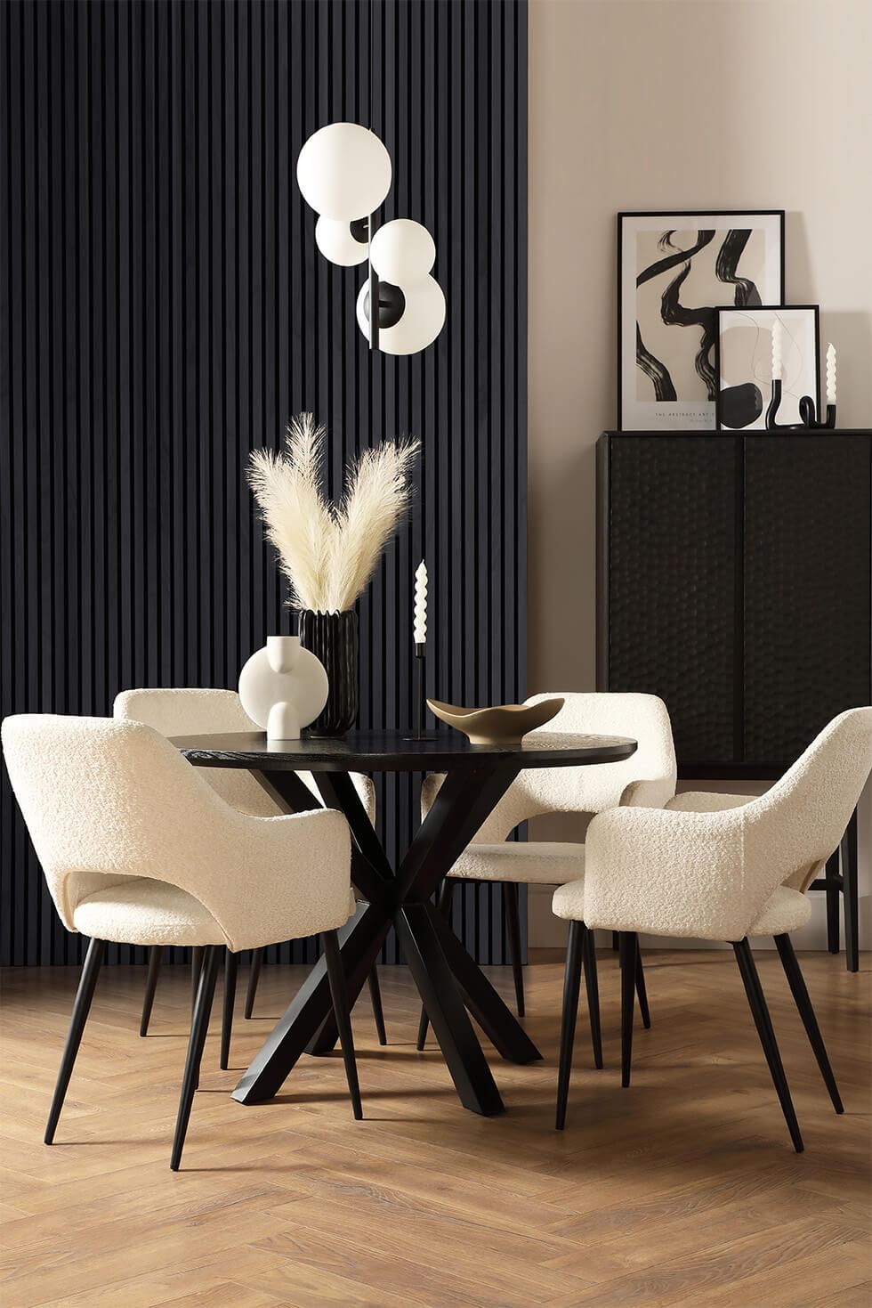 Small dining room with black wall slats and black and white dining set