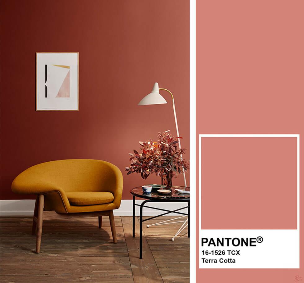 Living room with terracotta walls and mustard armchair.
