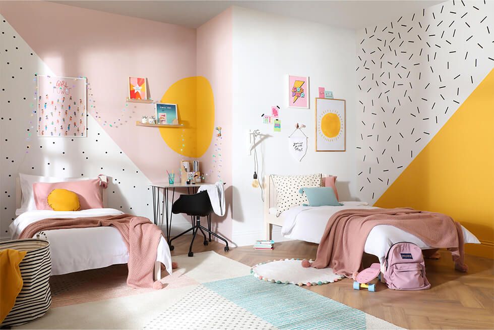 Shared kids bedroom with colour blocked walls in bright pastel colours