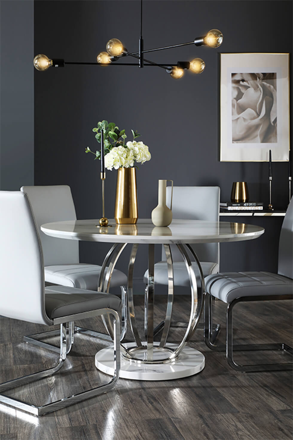 Dark grey dining room with white marble round dining table and grey leather chairs