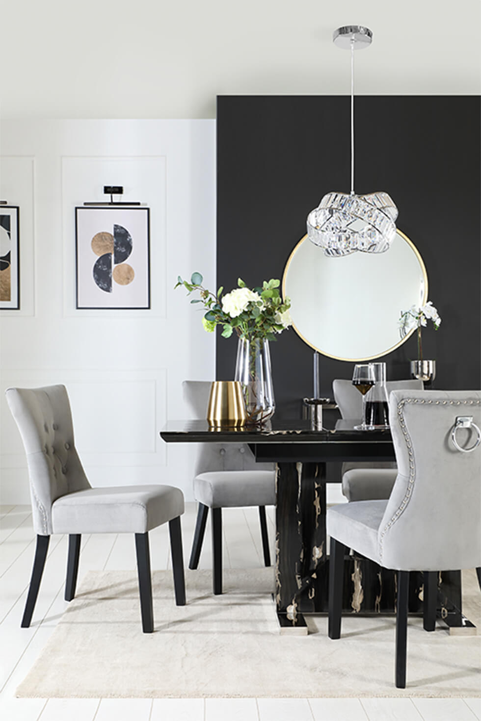 Modern black marble dining table with grey fabric chairs and pendant lamp