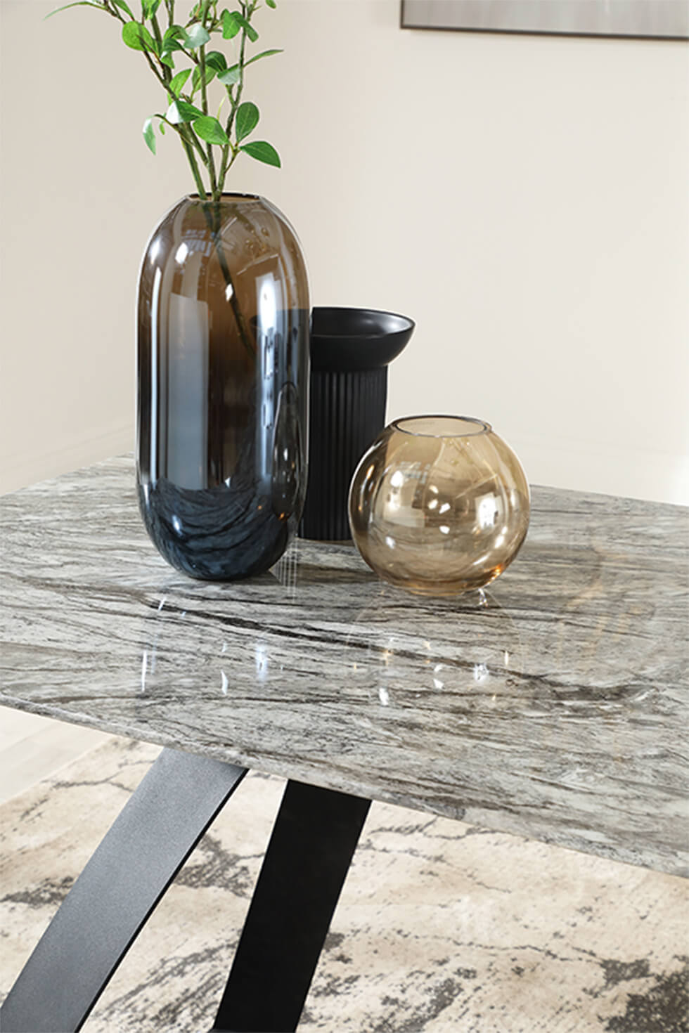 Warm grey dining table with black legs and smoked glass vases